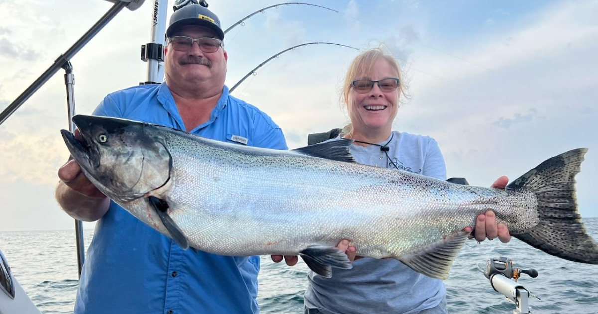 Giant Salmon Couple holding giant salmon from Lake Michigan fishing charter