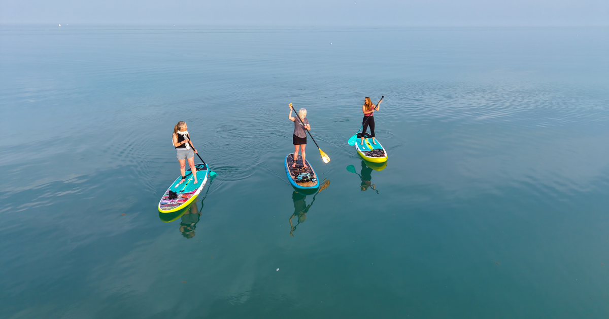 Paddleboarding women Women paddleboarding in Port Washington, WI