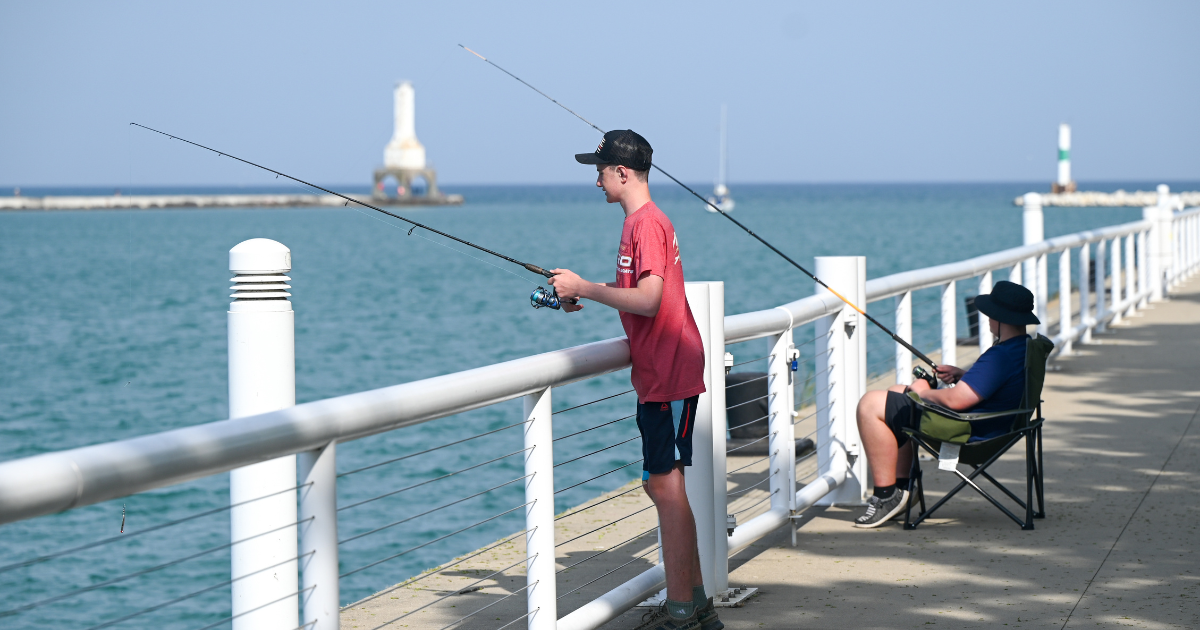Two People Fishing from Coal Dock Woman shore fishing from the Port Washington harbor