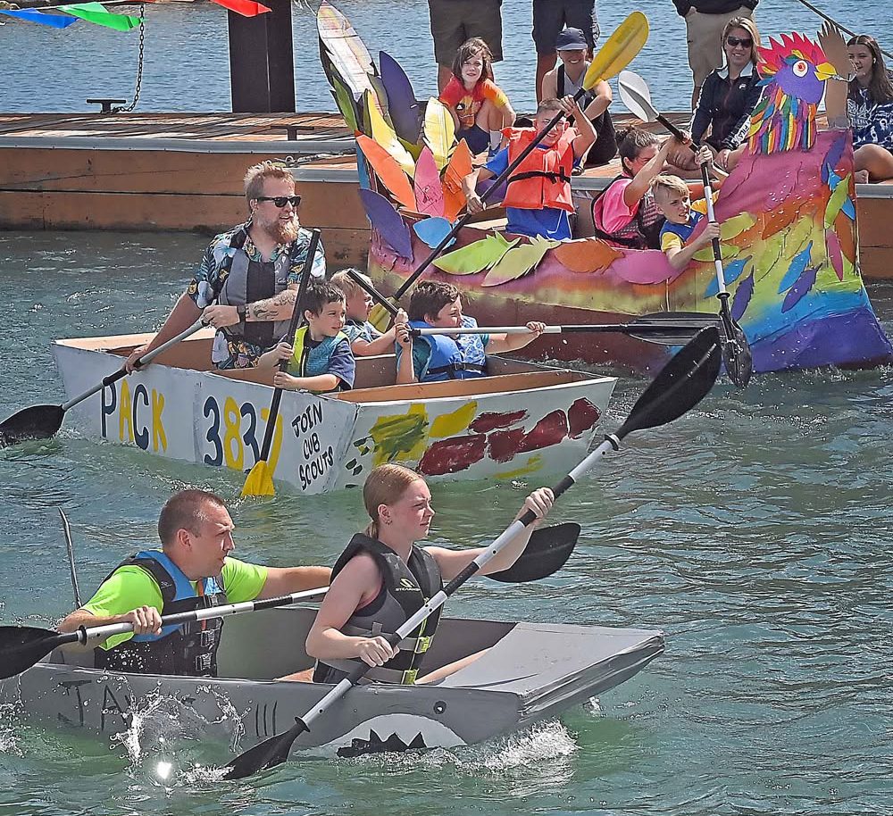 Boats competing in the cardboard boat regatta in the Port Washington harbor